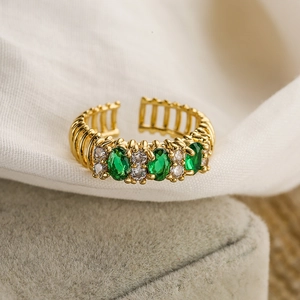 18K gold-plated open ring with green oval gemstone and white zircon on grey velvet box