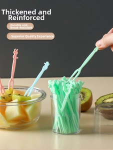 Close-up of animal-shaped two-tooth disposable fruit forks for dessert and snacks