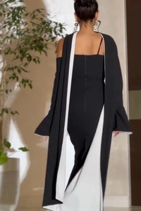 Detail of slim fit black dress featuring back invisible zipper and white contrast trim