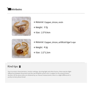 Detail view of gold-plated rings with tiger's eye and cubic zirconia size specifications