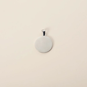Close-up of polished round stainless steel pet tag with ring for custom engraving