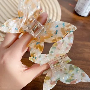 Colorful butterfly hair claw clips in marble acetate finish for elegant hairstyling