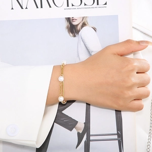 Elegant double-layered gold stainless steel bracelet with white pearls on a snake chain