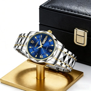 Luminous quartz watch with blue dial and two-tone steel strap on a premium display stand