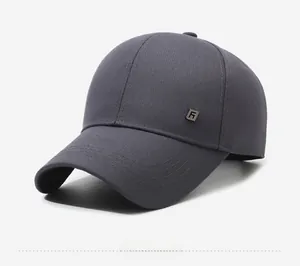 Detail view of charcoal grey baseball cap with twill cotton texture and square metal logo