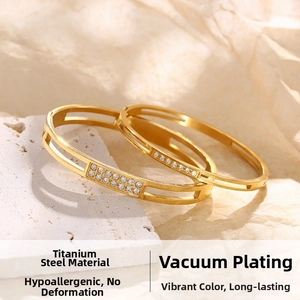 Detail of gold titanium steel bracelets featuring zircon inlay and vacuum plating