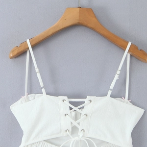 Lace-up white camisole mini dress with thin straps and textured fabric detailing
