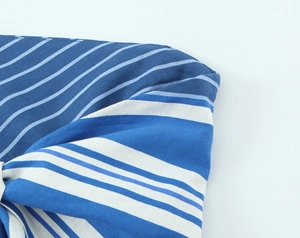 Macro view of blue and white striped linen fabric with detailed precision stitching