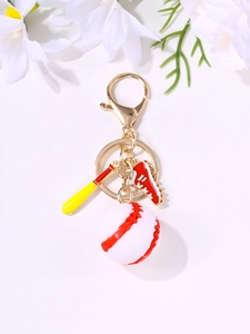 Detail of baseball keychain with golden hook, mini bat, sneaker, and realistic ball