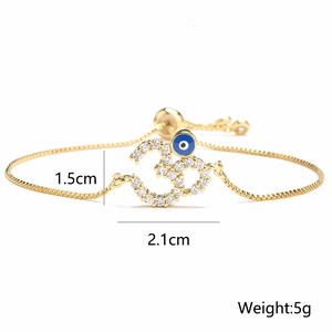 Bracciale placcato oro 18 carati con simbolo Om in zirconi e ciondolo occhio blu