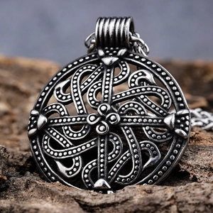 Vintage silver Celtic knot stainless steel pendant on a dark rustic wood background