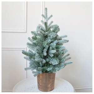 Close-up of a 60cm mini flocked Christmas tree in a brown striped pot for festive decor