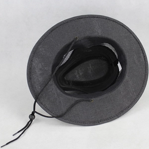 Detail view of breathable black mesh lining and adjustable chin strap on straw sun hat