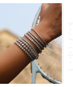 Detailweergave van zilveren tennisarmbanden met VVS1 moissanietstenen op een model