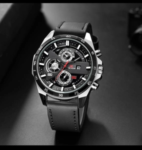 Macro detail of men's chronograph watch with black leather strap and tachymeter bezel