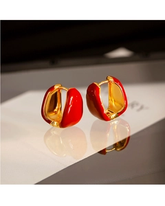 Macro detail of French vintage red enamel and gold plated teardrop hoop earrings