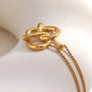 Polished 18K gold-plated stainless steel knotted heart pendant on a minimalist chain