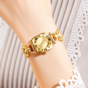 Close-up of golden square dial vintage watch with chain bracelet on a woman's wrist