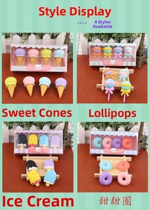 Detail view of colorful dessert-shaped erasers including donuts and ice cream in gift boxes