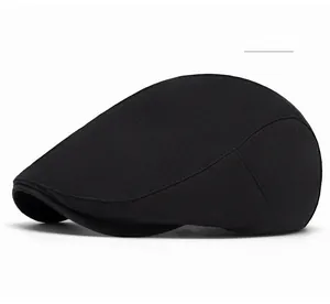 Detailed side view of black cotton flat cap showing smooth fabric texture and stitching