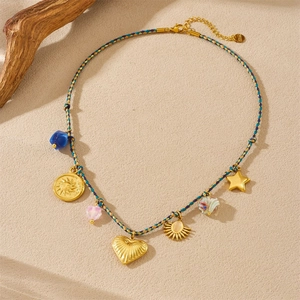 Detail of woven rope necklace with stainless steel gold star and heart charms