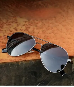 Detail of aviator polarized sunglasses with black metal frame on industrial background