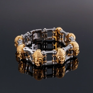 Detailed close-up of motorcycle chain bracelet with embossed golden Buddha heads