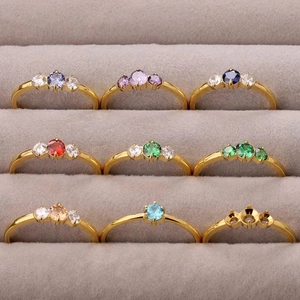 Vintage gold titanium steel rings set with colorful zircons in a professional display