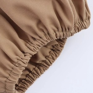 Close-up of elastic puff sleeve cuff on a khaki French vintage v-neck maxi dress