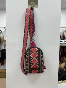 Close-up of bohemian geometric print canvas chest bag with wide strap and leather logo