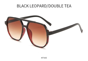 Detail view of double bridge sunglasses with black frames and leopard inner rims