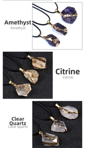 Close-up of raw amethyst citrine and clear quartz pendants with gold-plated edges