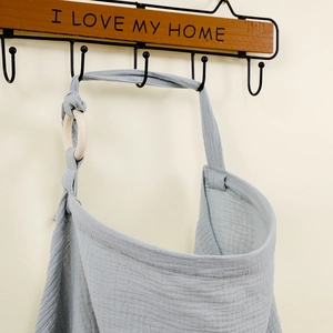 Detail of grey cotton muslin hanging storage bag with I LOVE MY HOME text and wood ring