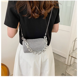 Silver rhinestone mini square bag shown on model with chic metallic chain straps