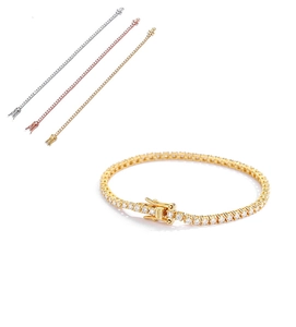Detail view of gold, silver, and rose gold tennis bracelets with secure safety clasp