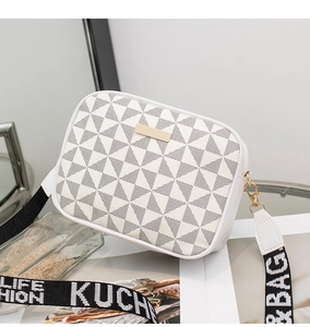 Detail of white geometric pattern crossbody bag with golden plaque and wide woven strap