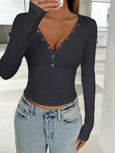 Detailed view of women's black V-neck Henley shirt with ribbed texture and silver buttons