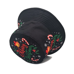 Detail of Christmas print on black cotton bucket hat with Merry Christmas text and motifs
