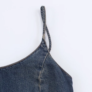 Detail of shoulder strap and neckline on washed dark blue denim midi dress
