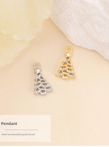 Detailed view of gold and silver Christmas tree pendants with cubic zirconia inlay
