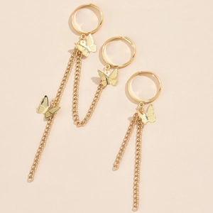 Detailed view of gold butterfly sequin ring bracelets with layered chain design