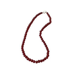 Deep red glass beaded necklace with glossy finish and silver ring clasp on white background
