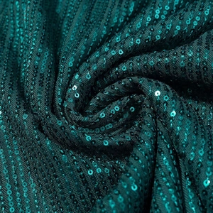 Sparkly dark green sequin party dress fabric detail with elegant shimmering texture