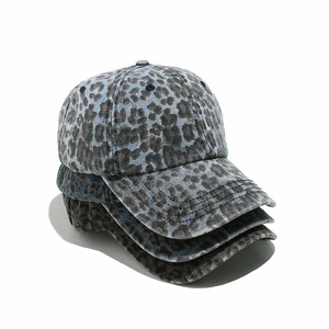 Three leopard print baseball caps in blue, grey, and brown with washed denim texture