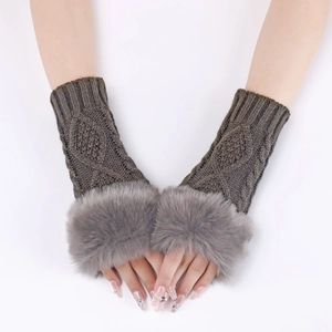 Close-up of knit fingerless gloves with grey faux fur trim and diamond cable pattern