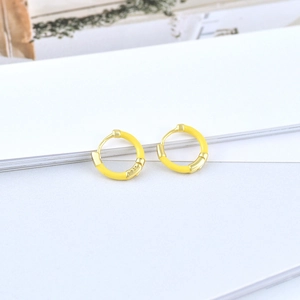 Macro shot of S925 sterling silver hoop earrings with bright yellow enamel finish