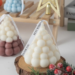 Christmas tree shaped scented candle set with decorative ribbons and festive ornaments
