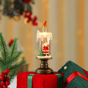 Detail of Santa Claus and Christmas tree inside a lighted candle lamp with bronze base