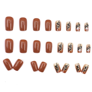 Caramel brown square press-on nails set with leaf patterns and gold foil flakes