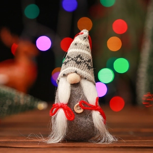 Close-up of a handmade Christmas gnome doll with a knitted hat and white beard detail